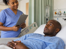 Patient awake in hospital recovery bed with nurse nearby, concerned expressions.